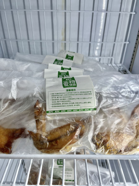 淘金路肯德基食物驿站冰柜里存放的冷冻炸鸡，均用保鲜袋密封，并贴有食品安全提示标签。摄影/本刊记者 龚怡洁